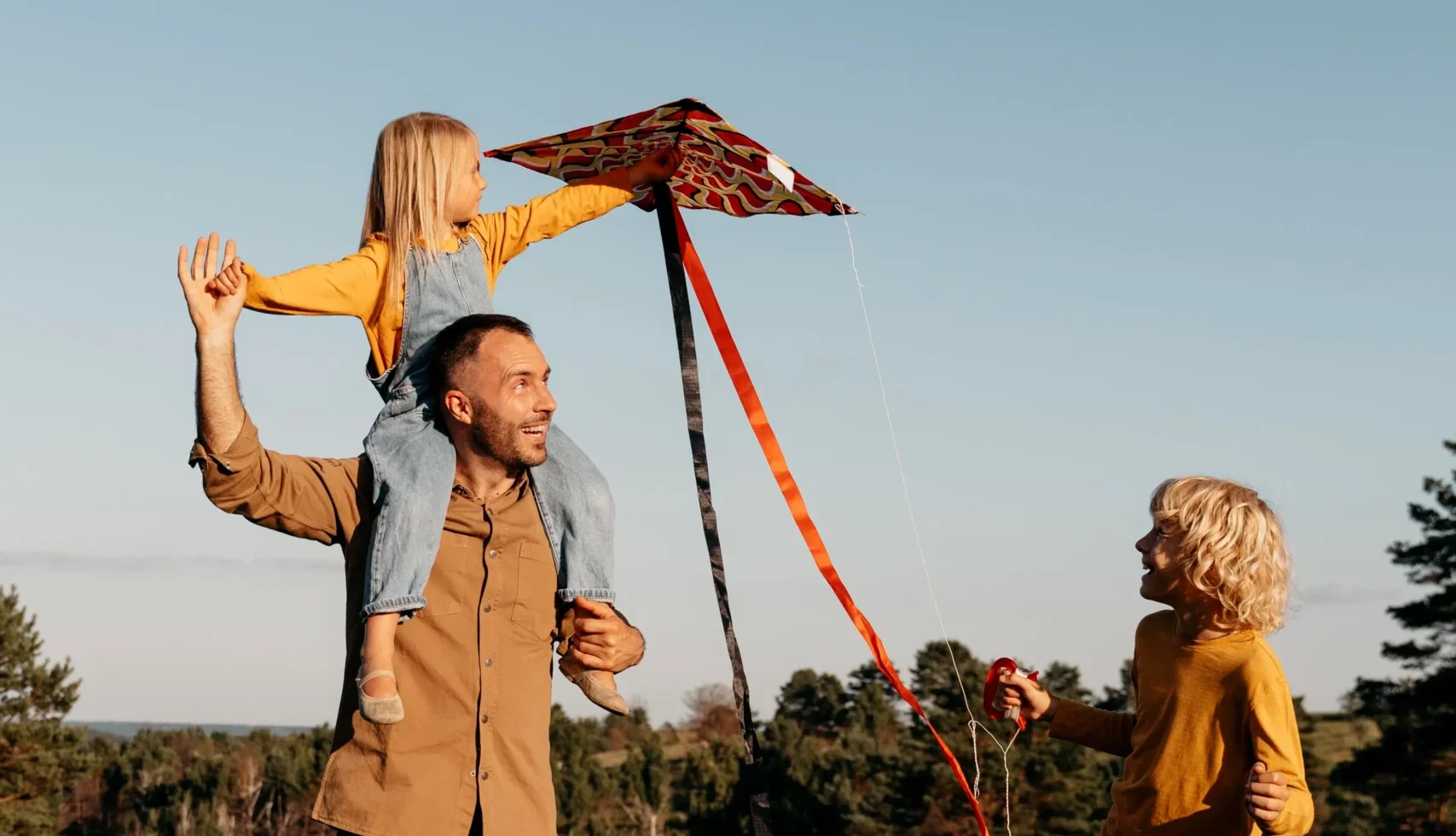 full-shot-family-playing-with-kite